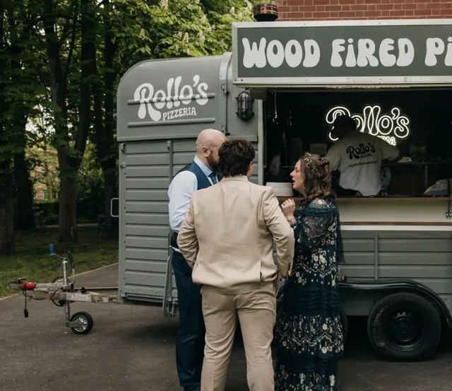 Wedding guests chatting at the horsebox